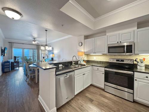 a kitchen with white cabinets and a counter top at Sunset Crossing in Gulf Shores