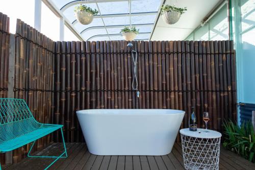 a bath tub on a deck with a wooden fence at MP Beach Club in Tootgarook