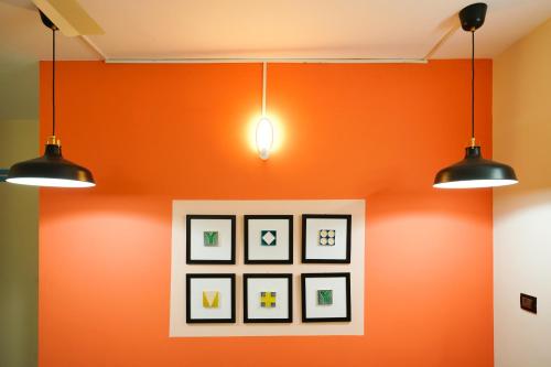 a room with two lights and a picture on the wall at Hotel O Majestic Stays in Kazhakuttam