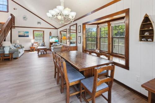 a dining room with a wooden table and chairs at 2029 - Duck Yeah in Duck