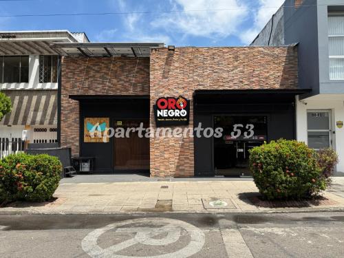 a store with a sign on the front of a building at Apartamentos 53 in Barrancabermeja