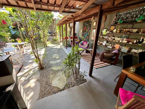 a patio with tables and chairs in a store at Tatu Do Bem Hospedagem in Serra