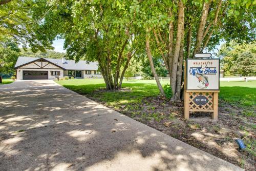 a sign in front of a building with trees at Cotter Home with Direct Access to White River! in Cotter