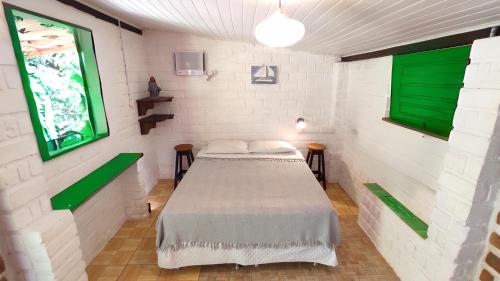 a bedroom with a bed in a room with green accents at Estalagem Santo André in Santo André