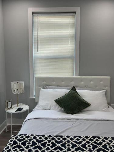 a bedroom with a bed with a large window at New 1BR Walk to Pats & Genos in Philadelphia