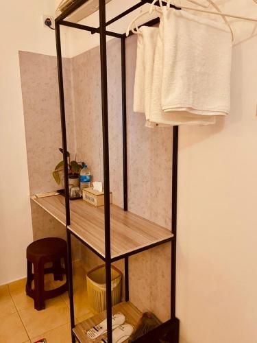 a room with a shelf with towels on a wall at Bees Airport Hotel in Katunayaka