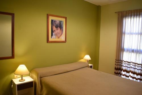 Ένα ή περισσότερα κρεβάτια σε δωμάτιο στο Apart Hotel El Portico