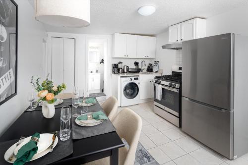 a kitchen with a dining table and a refrigerator at Bright 1BR Escape in Lower East Side NYC in New York