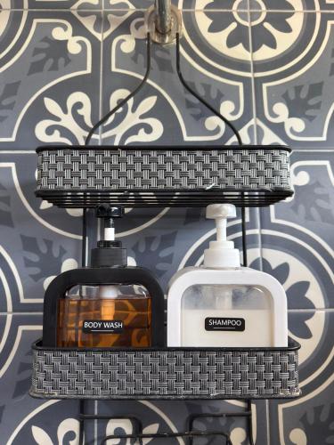 a shelf with two soap dispensers on a wall at Casa de Campo Lake Shore Jocotepec in San Cristóbal Zapotitlán