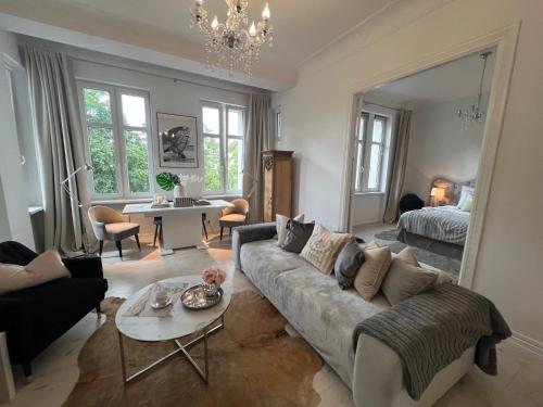 a living room with a couch and a table at APARTAMENT PARYSKI, Centrum Słupsk in Słupsk