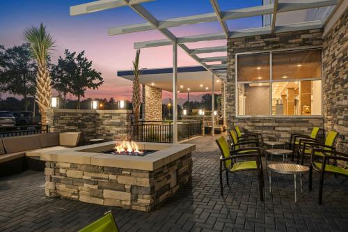 a patio with a fire pit and tables and chairs at SpringHill Suites by Marriott Camden in Camden