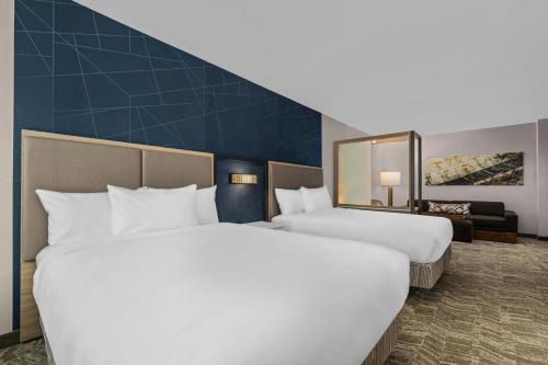 two white beds in a hotel room with a mirror at SpringHill Suites by Marriott Camden in Camden