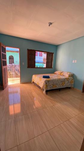 a bedroom with a bed and a wooden floor at Hospedaria Dona Alice in Lençóis