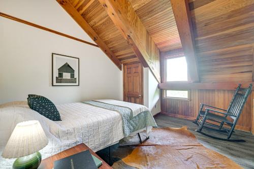 a bedroom with a bed and a chair in a room at Riverfront Hudson Valley Gem with Beach Access! in Athens