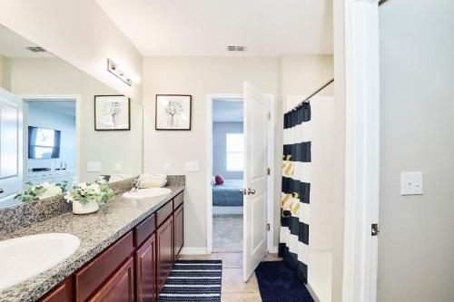 a bathroom with two sinks and a large mirror at GoldStar Luxury Home in Ruskin
