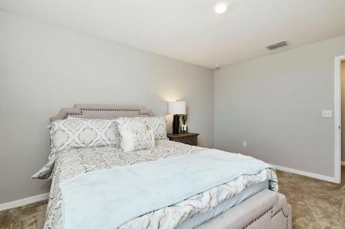 a white bedroom with a large bed and a window at GoldStar Luxury Home in Ruskin