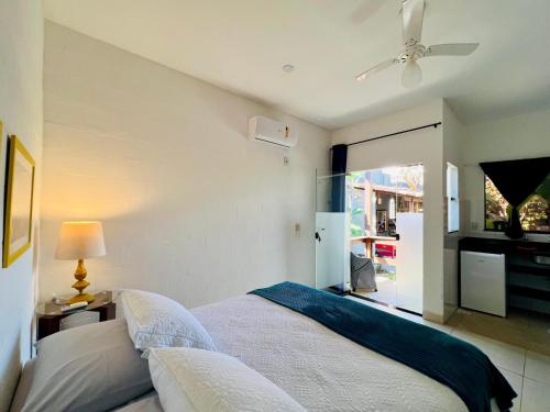 a bedroom with a bed and a ceiling fan at Tatu Do Bem Hospedagem in Serra