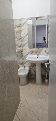 a bathroom with a sink and a toilet and a mirror at Casa da Vista Rio in Amora