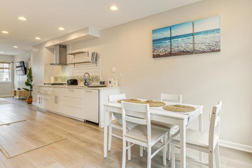a kitchen and dining room with a white table and chairs at Walkable Baltimore Rowhouse with Fenced-In Patio! in Baltimore