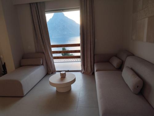 a living room with a view of a mountain at Vouros Villages - Suites in Masouri