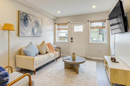 a living room with a couch and a table at Walkable Baltimore Rowhouse with Fenced-In Patio! in Baltimore