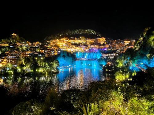 a view of a city lit up at night at 笑涡SmileNest Downtown Luxury Suite for 2-10 Guests, Zhangjiajie Attraction Ticket Service, Ideal for Couples, Families & Groups in Zhangjiajie