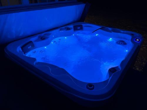 a blue bath tub in a dark room at Private Cabin on 90 Acres! in Wright City