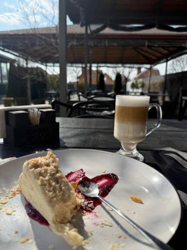 a piece of cake on a plate next to a cup of coffee at Biruza Club in Svyatopetrivske