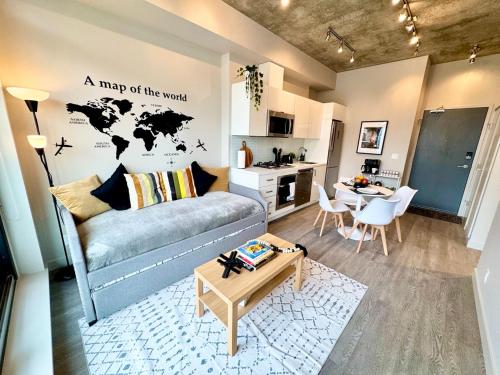 a living room with a couch and a map of the world at Elegant, Comfy & Sophisticated MetroLux Downtown Suite in Calgary