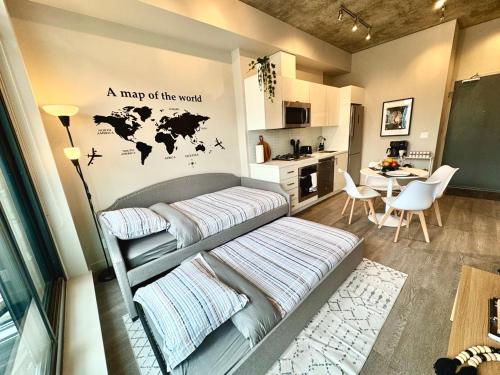 a bedroom with a bed with a map of the world on the wall at Elegant, Comfy & Sophisticated MetroLux Downtown Suite in Calgary