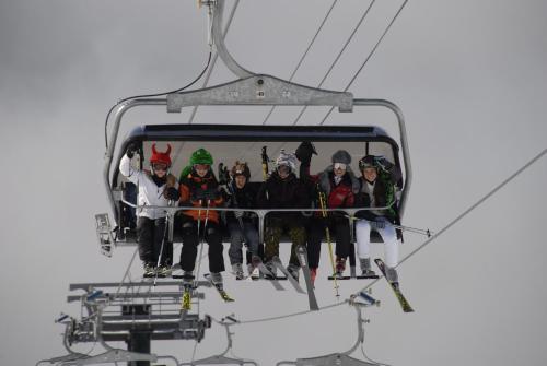a group of people sitting on a ski lift at Galileo Boutique Hotel in San Carlos de Bariloche