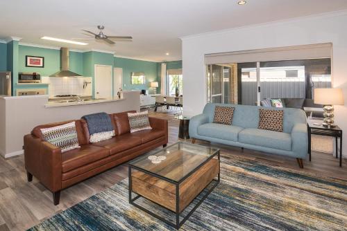 a living room with a couch and a table at Blue Retreat in Geographe