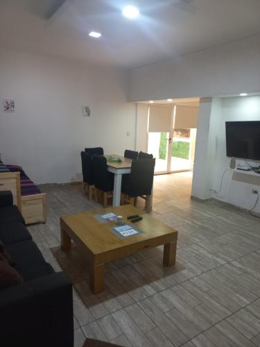a living room with a table and chairs and a tv at Maryhouse2 in Lomas de Zamora