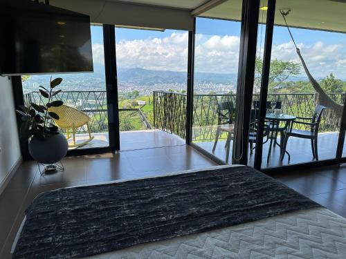 a bedroom with a bed and a balcony with a view at BALCÓN DE SANTA MARÍA 2 in Dosquebradas