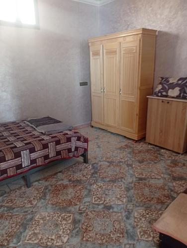 a bedroom with a bed and a cabinet in it at Villa De Compagne 