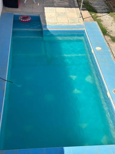 a blue swimming pool with fish in the water at Villa De Compagne 
