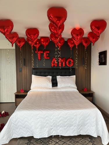 a bedroom with a bed with red hearts on the wall at BALCÓN DE SANTA MARÍA 2 in Dosquebradas