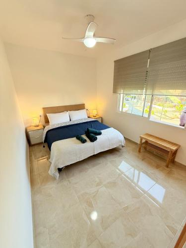 a bedroom with a bed and a large window at Villa del sol in Creixell