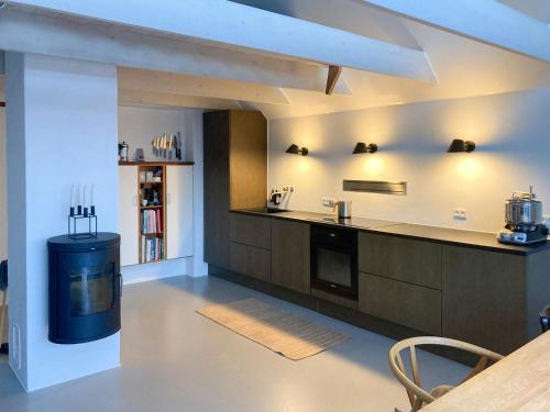 a kitchen with a sink and a counter top at Beach House With Sauna By Norsminde Harbour in Malling