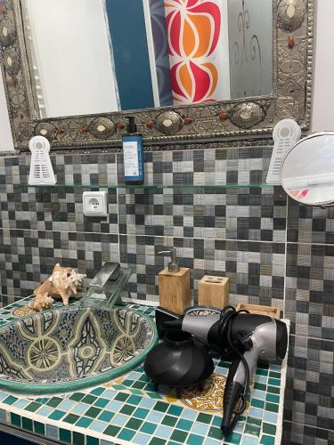 a bathroom sink with a blow dryer on a counter at Meyssa's Paradise in Tangier