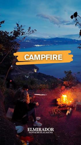 a group of people sitting around a camp fire at Bee Fresh Camping y Mirador in Santa Cruz La Laguna