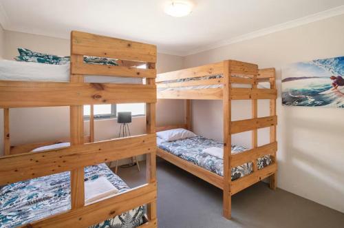 a room with two bunk beds and a desk at Marina Family Beachscape in Geographe