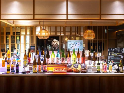 a bar with a lot of bottles of wine at Super Hotel Premier Toyama Castle Park in Toyama