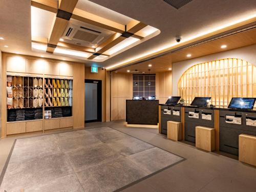 a dressing room with a bunch of bottles of wine at Super Hotel Premier Toyama Castle Park in Toyama