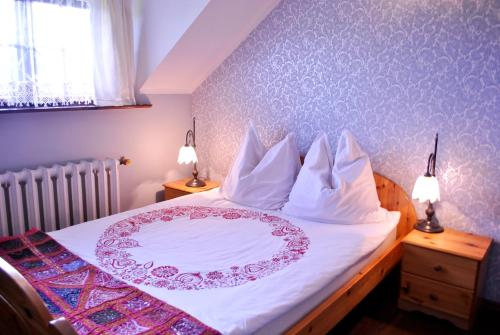 a bedroom with a bed with a plate on it at Agroturystyka u Karoliny in Sarbinowo