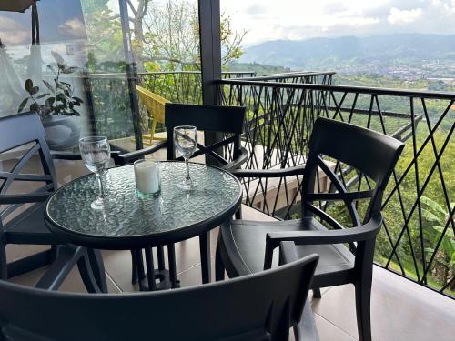 a table and chairs on a balcony with a view at BALCÓN DE SANTA MARÍA 2 in Dosquebradas