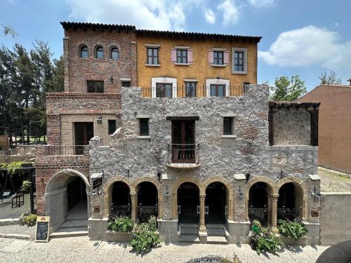 an old brick building with a large building at Loft Nizza en ValQuirico a 50 mts Plaza del Zocalo in Santeagueda