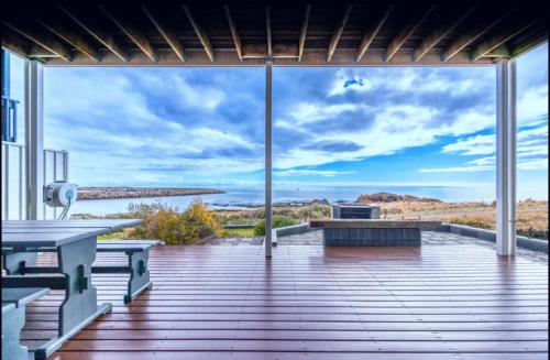 a deck with benches and a view of the ocean at Ocean Front retreat Fleurieu Coast Wirrina Cove in Wirrina Cove