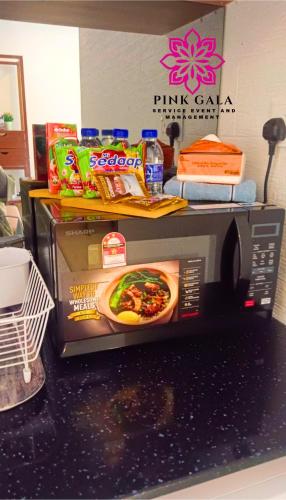 a microwave on a counter with food on top of it at Timurbay Sidecation Studio - Walk to Beach, Enjoy Pool & Sea View by PG Management in Kampung Saberang Balok