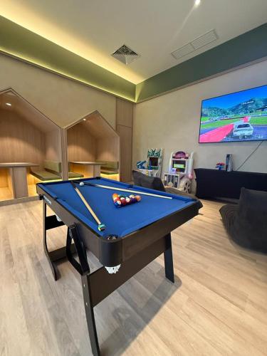 a living room with a pool table and a tv at Wyndham Ion Majestic Genting Highlands in Genting Highlands